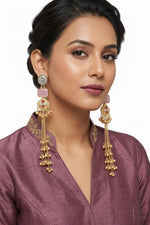 Elegant gold-toned laurel leaf earrings featuring a soft pink-colored cushion-cut stone drop worn by our model.
