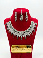 Silver plated bridal necklace set with emerald green stones, cubic zirconia, matching earrings and maang tikka – The Sheeba"
