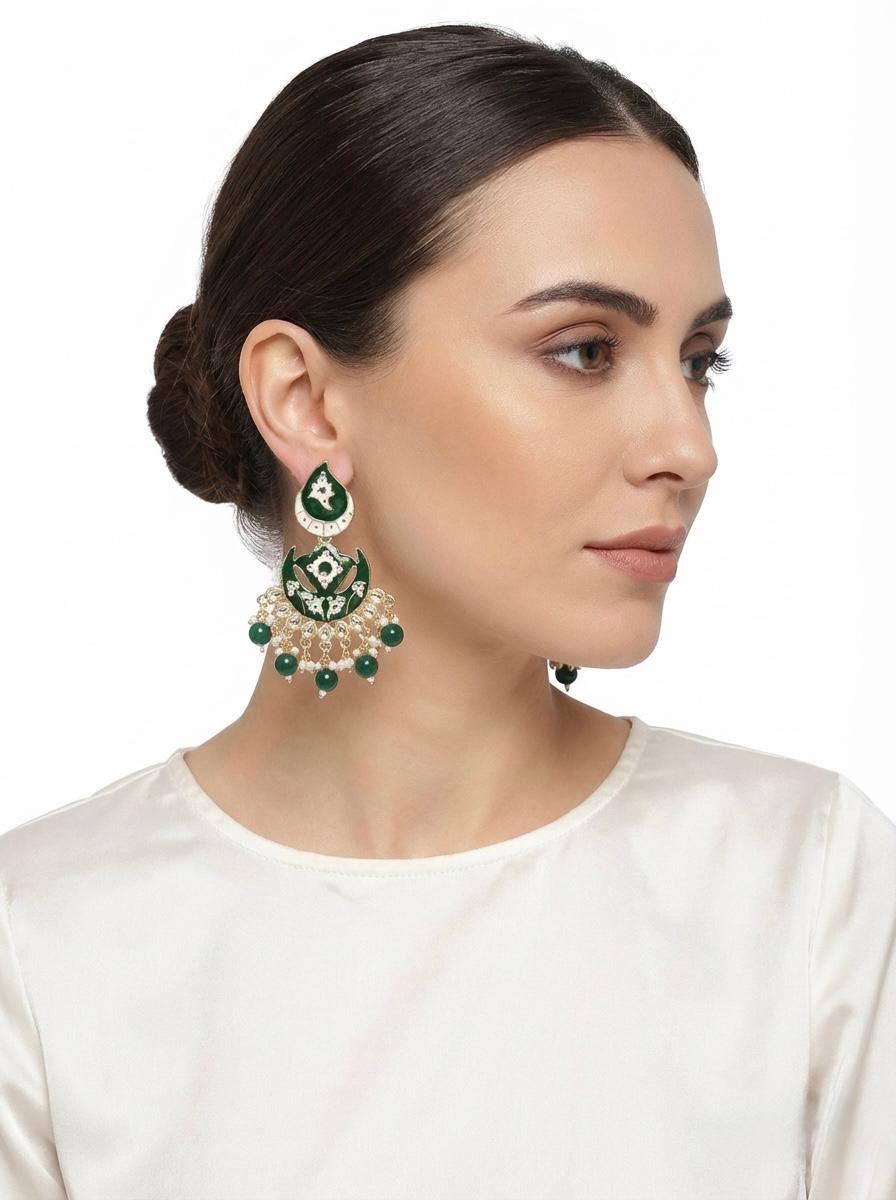 Emerald green earrings on our model, a bold, eye-catching profile.