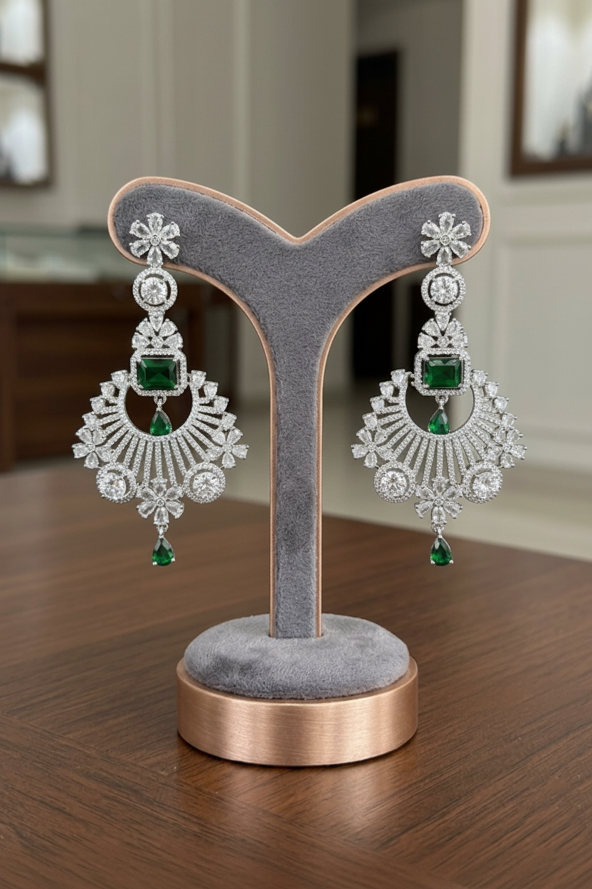 Emerald green royalty American Diamond statement chandelier earrings on display.