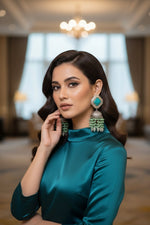 The earrings carries the blue stone in the top stud and apple green hangings underneath the Jhumkey dome and nano oxidised hanging in in the last