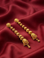 Close-up detail of intricate 22K gold plated filigree pattern on drop earrings