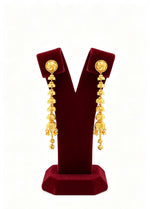 a pair of gold plated 7cm drop length earrings displayed on a stand