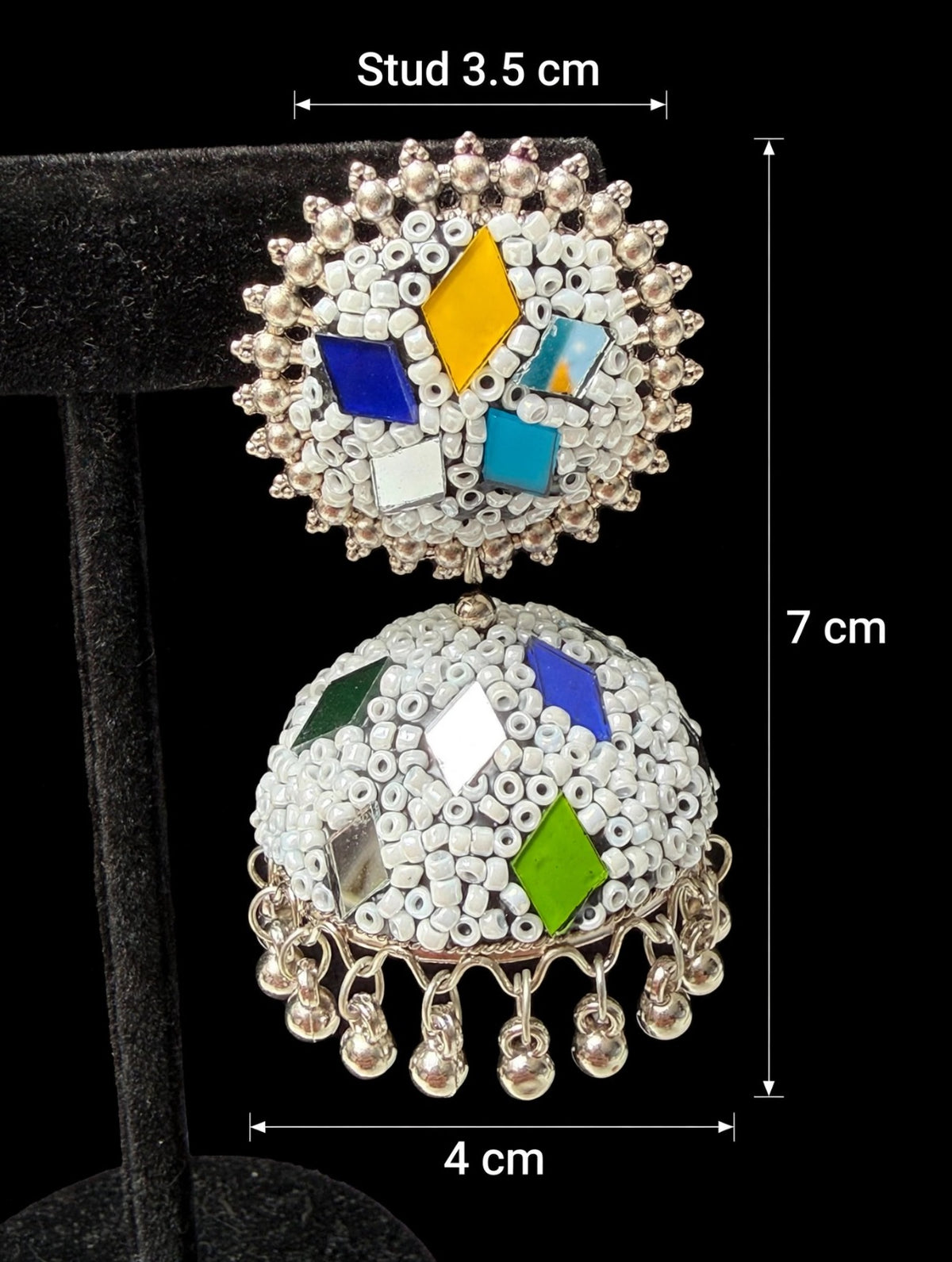 Dimensioned white multi-color meenakari jhumka — stud 3.5cm, dome 4cm, total drop 7cm; cobalt blue, golden yellow, turquoise, emerald green diamond patches, silver mirror inlays, silver-tone ghungroos — Famaza Couture.