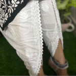 Detail of the fabric and design of white dhoti pants