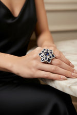 Posh model wearing the Famaza Couture Royal Midnight Blossom American Diamond and blue sapphire floral cocktail ring.