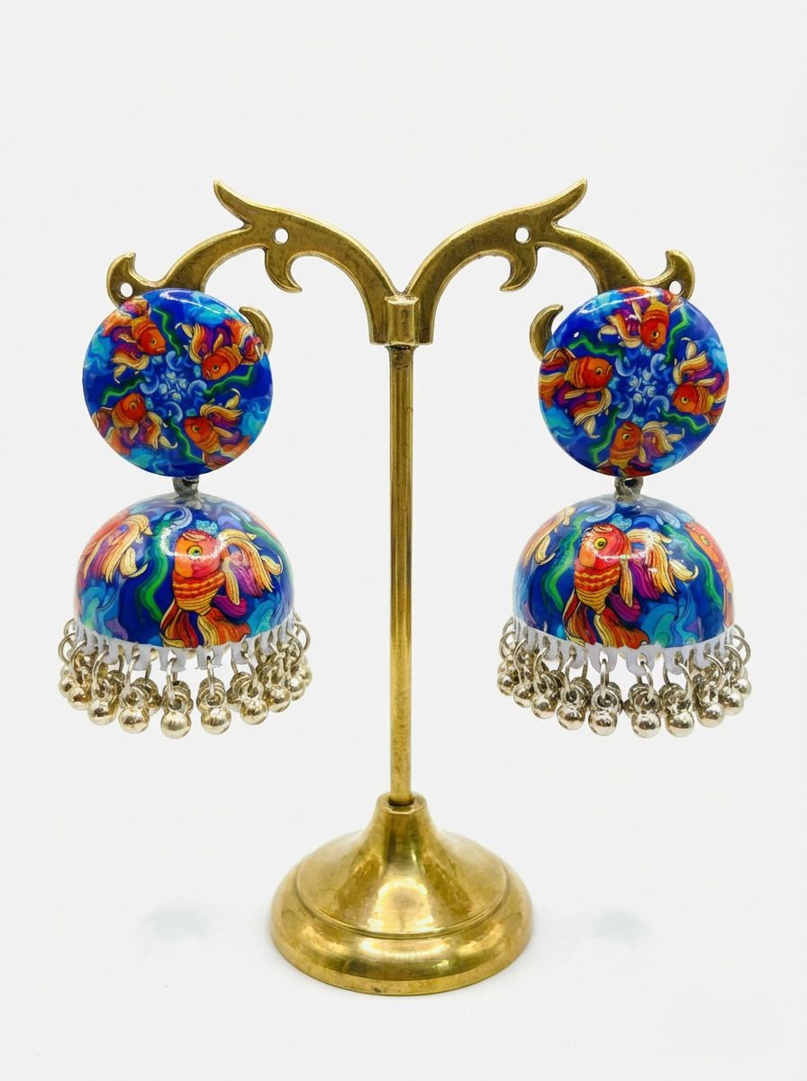 Front view of hand-painted enamel jhumka earrings featuring a vibrant blue Koi fish design.