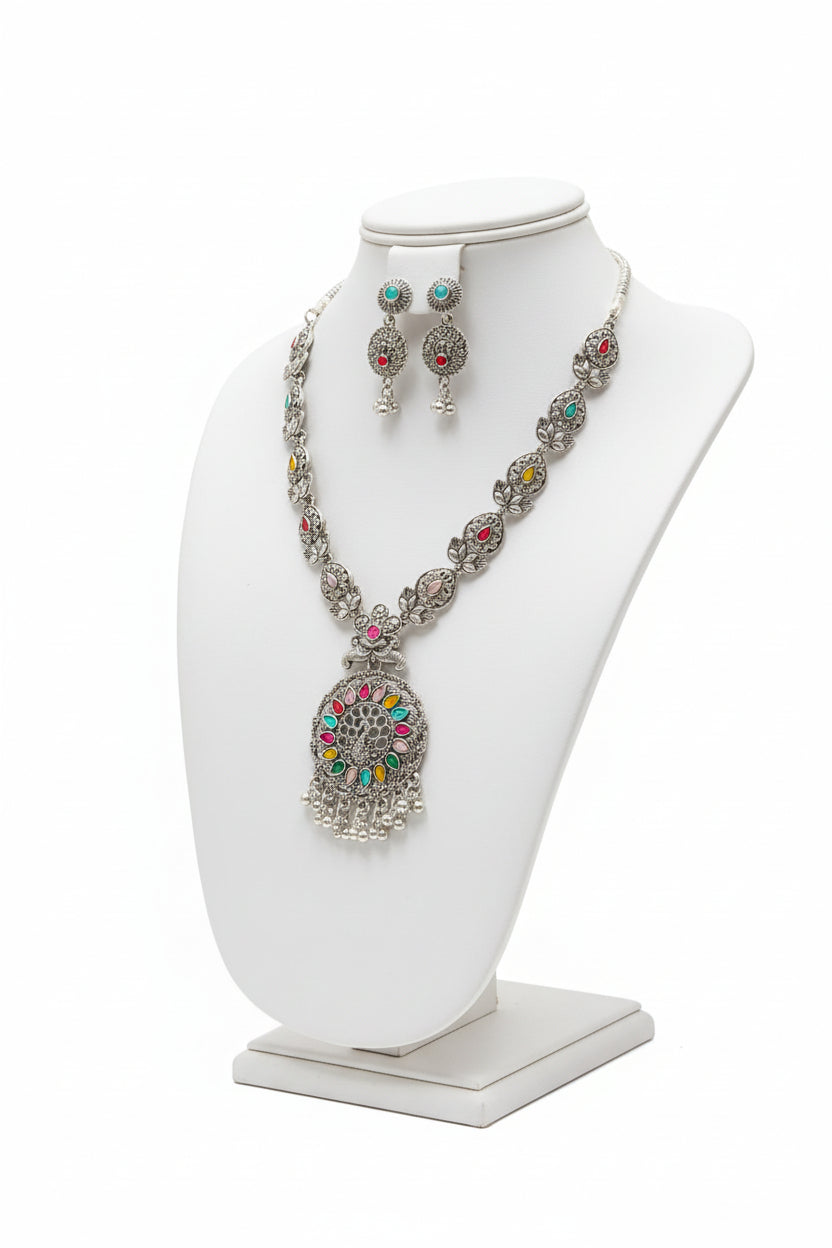 Full view of the artisan brass necklace and earring set displayed on a jewelry bust.