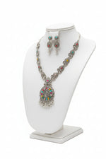 Full view of the artisan brass necklace and earring set displayed on a jewelry bust.