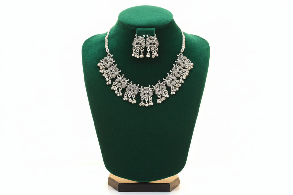 Full view of the artisan floral-motif choker and earring set displayed on a black velvet jewelry bust.