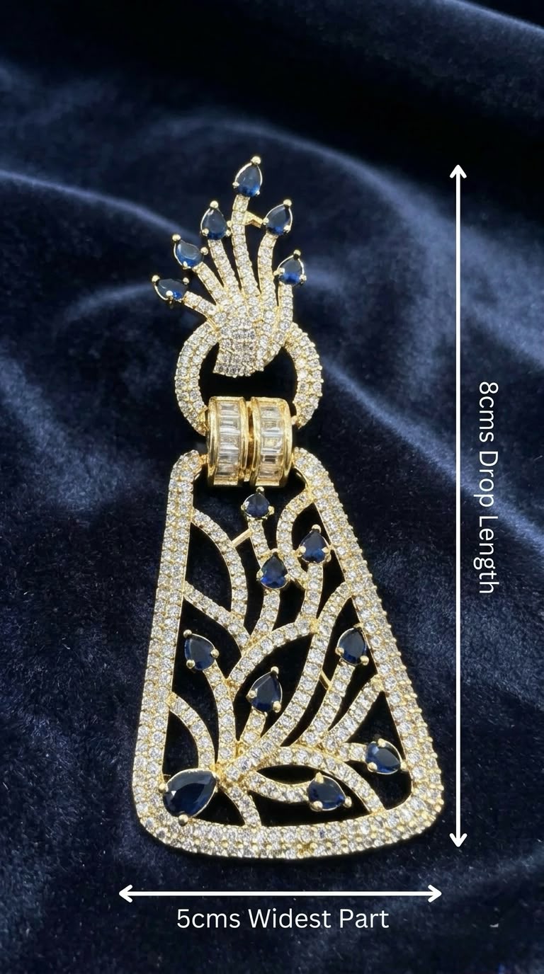 Pair of gold-plated dangle earrings featuring royal blue stones and American Diamond filigree lattice work on a posh display stand.