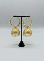 Gold jewelry with pearls on a textured surface