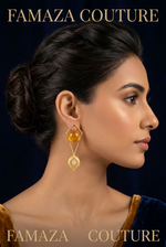 Model is wearing and showing the gold tone stone geometric dangle earring