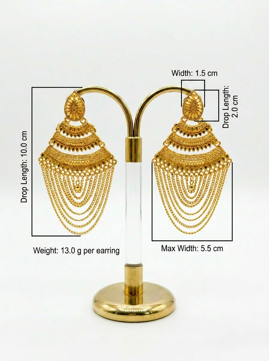Gold earrings on a stand with measurements displayed.