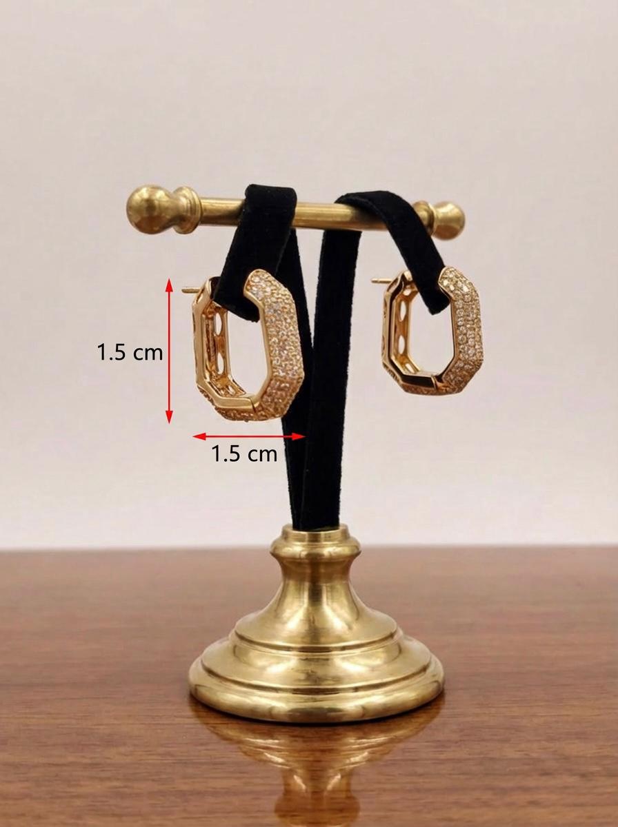 Gold hoop earrings on a stand with measurements indicated