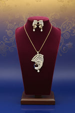Gold plated a set of peacock-shaped pendant in golden chain with peacock-shaped earrings. The pendant is detailed with blue enamel and has sparkling crystal white AD stones embellishments.