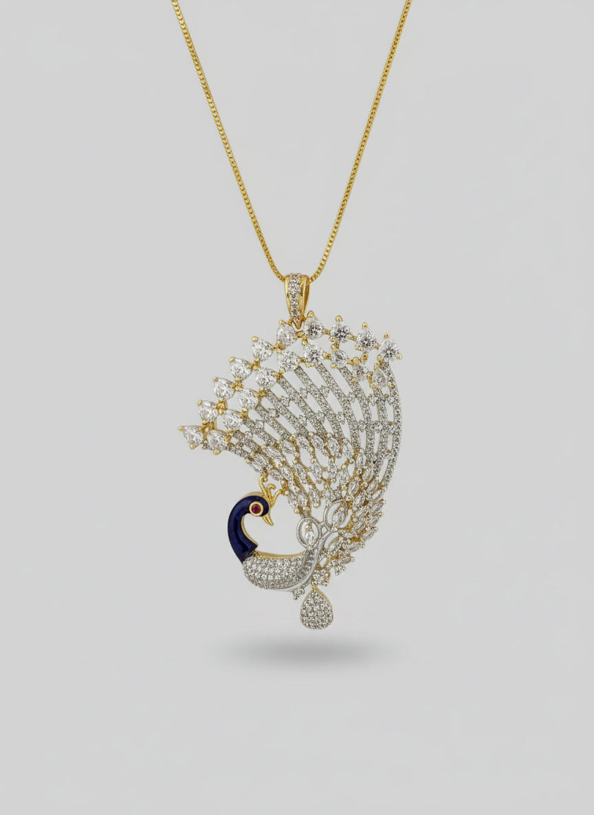 Gold plated peacock-shaped pendant in gold chain The pendant is detailed with blue, and gold enamel and has sparkling white AD stones crystal embellishments. Pendant is in focused.