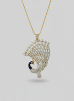 Gold plated peacock-shaped pendant in gold chain The pendant is detailed with blue, and gold enamel and has sparkling white AD stones crystal embellishments. Pendant is in focused.