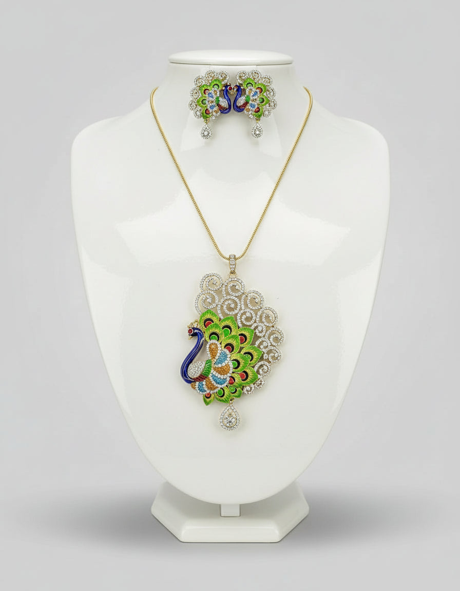 Gold polished a peacock full open wings design pendant with vibrant green, blue, and gold enamel accents, along with white ad stones sparkling embellishments, accompanied by matching earrings, displayed on a black mannequin necklace stand.