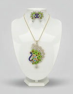 Gold polished a peacock full open wings design pendant with vibrant green, blue, and gold enamel accents, along with white ad stones sparkling embellishments, accompanied by matching earrings, displayed on a black mannequin necklace stand.