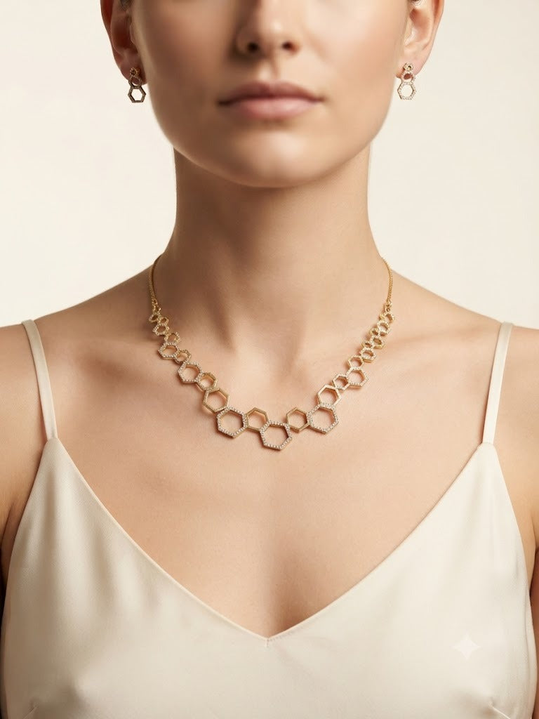 A model wearing a sophisticated 18k gold plated geometric necklace composed of linked hexagons with matching stud earrings, showcasing elite craftsmanship and contemporary elegance.
