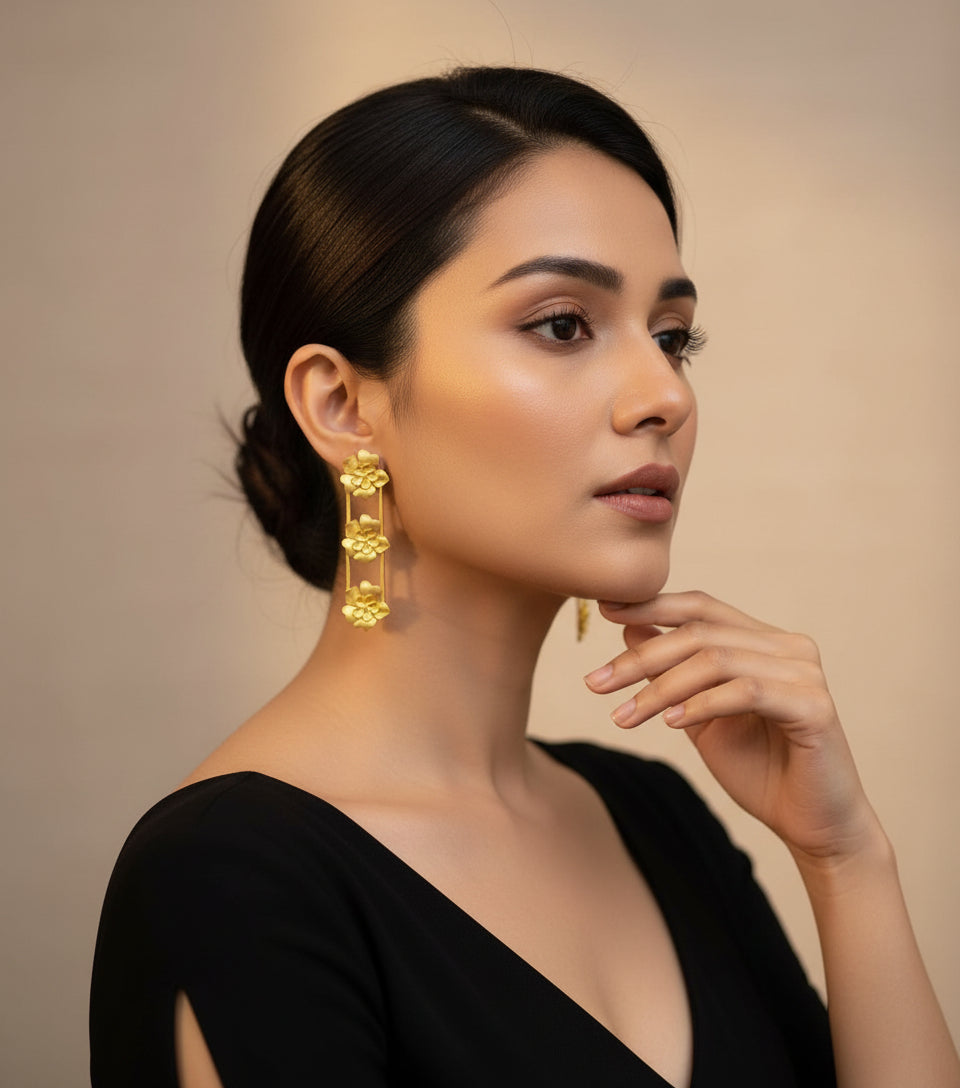 Golden colour3 flowers in down line detailed party wear earrings.