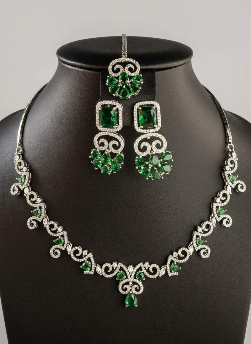 Green gemstone necklace and earrings on a black mannequin by famaza couture