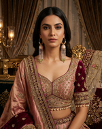 Woman in traditional embroidered outfit with gold jewelry in a decorative setting
