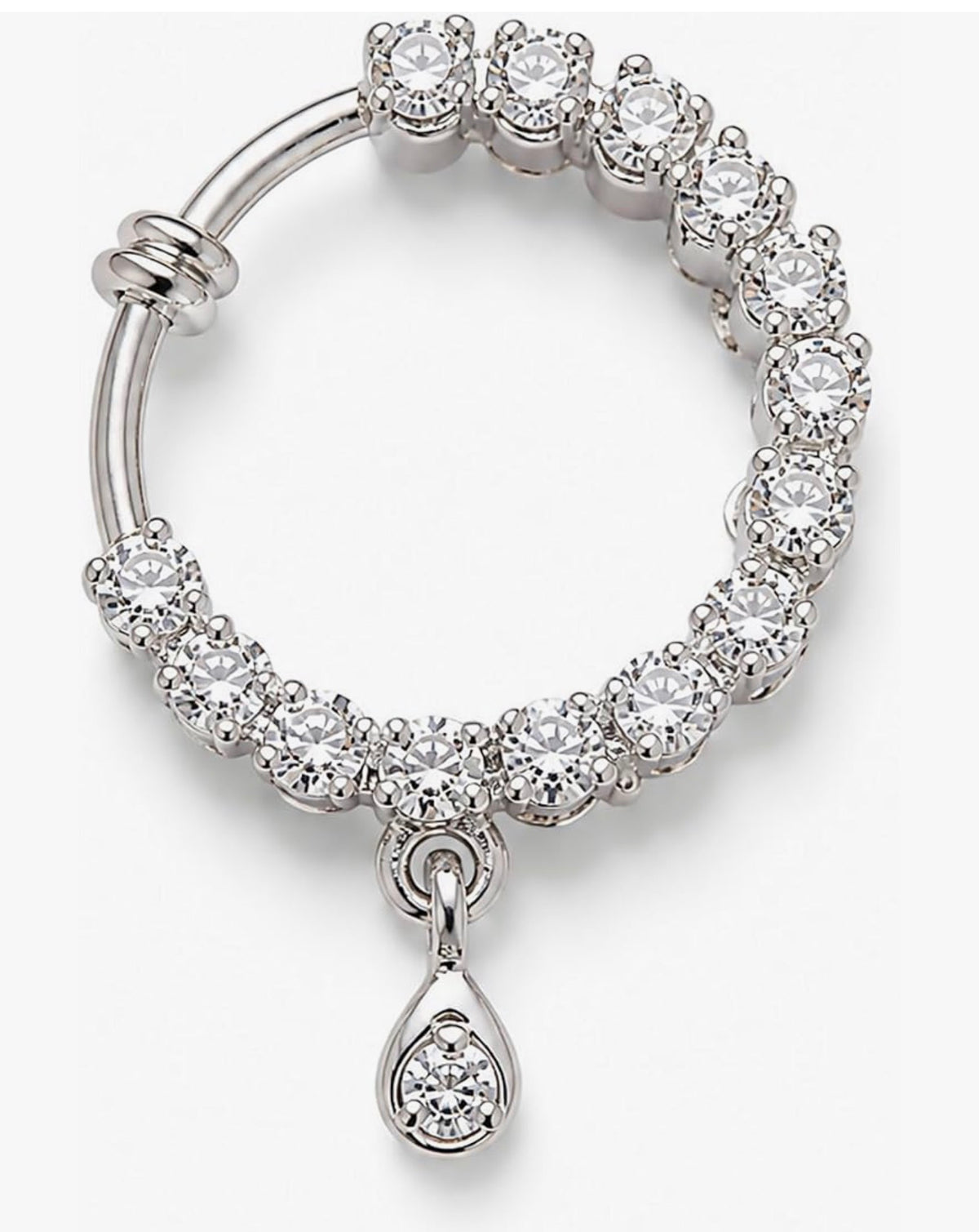 A silver-toned huggie hoop earring adorned with round-cut clear crystals and featuring a dangling teardrop-shaped crystal cluster charm, shown on a light gray background.