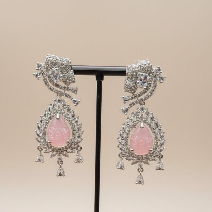Intricate American Diamond setting with a mix of marquise and round stones surrounding a central pink sugar stone.