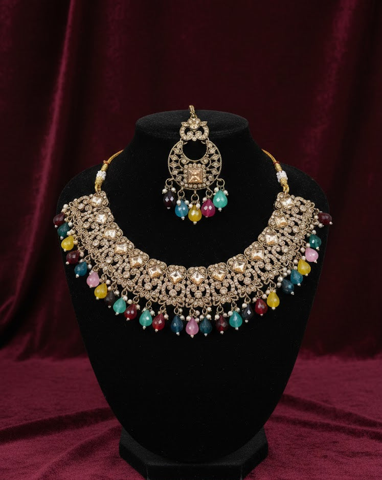 Jewelry set with necklace and earrings on a black stand against a red background
