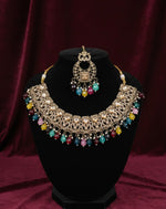 Jewelry set with necklace and earrings on a black stand against a red background