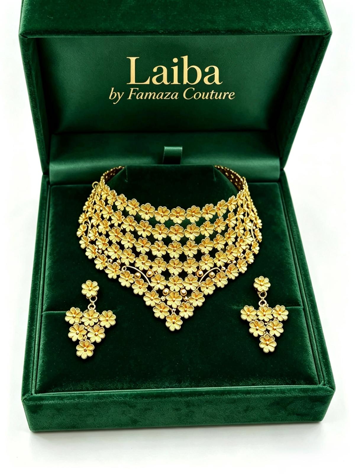 A close-up of the Laiba floral filigree gold collar necklace and matching earrings presented in a luxury green velvet box.