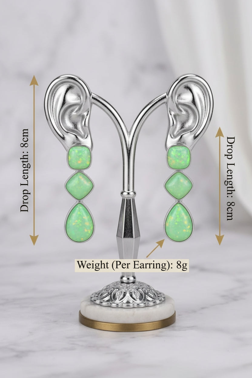 A pair of high-end three-tier drop statement earrings with a shimmering, iridescent lime-green finish displayed on a rose gold ear-shaped jewelry stand. Infographic text indicators specify a drop length of 8cm and a single earring weight of 8g.