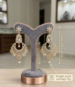 A studio product shot of gold-toned chand bali earrings displayed on a grey velvet jewelry stand, annotated with technical specifications: total drop length of 8cm, bottom chand bali section of 4cm, and a weight of 17 grams per earring.