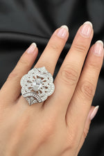 Luxury marquise-shaped adjustable cocktail ring featuring a brilliant white gem and floral accents.