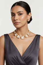 Luxury minimalist mother of pearl jewelry set worn by a model showcasing a rich elegant style.