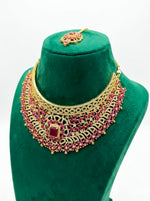 Luxury traditional ruby and gold statement bridal jewelry set presented in a premium display box.