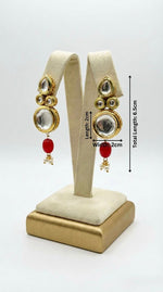Matching earrings of the regal Kundan bridal set displayed on a stand with the measurments.