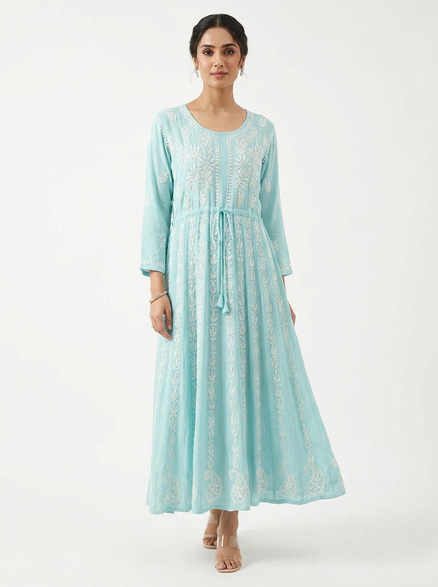 Model is showing the front view of this sky blue chikankari hand embroidered Aanarkali long dress.