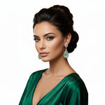Model is wearing AD earrings in pink and green stone .