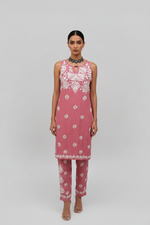 Model is wearing a pink dress with white floral patterns hand embroidery 2pc dress.