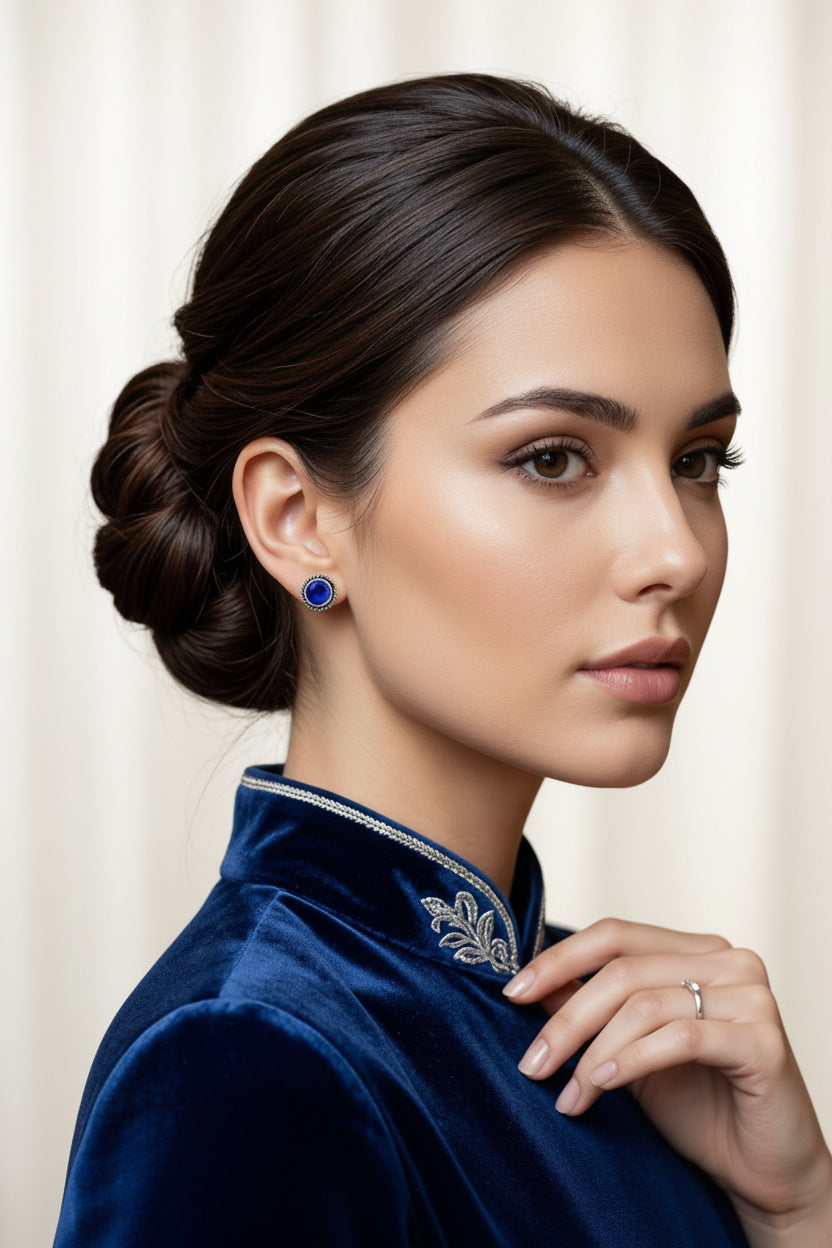 Model is wearing and showing the navy blue stone silver based stud earrings.