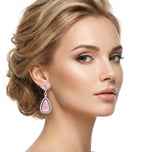 Model is wearing pink stone earrings.