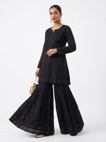 Model is wearing the black cotton Gharara with antique kaamdani work