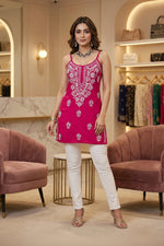 Model is wearing the short noodle tunic with straight white pants.