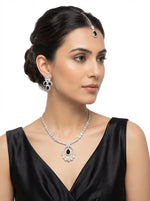 Model is wearing thisThe American diamonds bridal jewellery set including necklace, earrings and maang tikka with black central cubic zirconia stones.