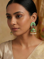 Model wearing 5.5cm seagreen Meenakari peacock jhumkas with an intricate traditional enamel finish.
