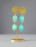 Mona lisa sky blue stone with golden studs.