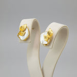 A Gold plated mother of pearl petal flower stud earrings by Famaza Couture